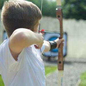 Boy doing archery at a CORNWALL COUNTY PLAYING FIELDS ASSOCIATION centre 